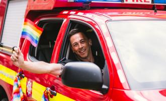 One of our firefighters flying the flag at Pride